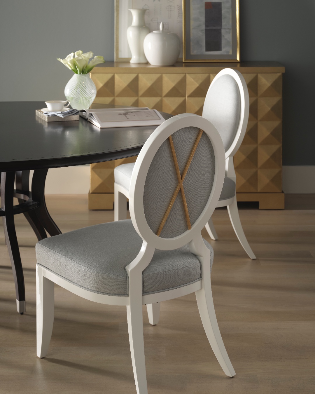 A signature piece from the timeless Barbara Barry Collection, the Oval X Dining Side Chair has been refined with a slightly more delicate and slender appearance. Soft feminine movement defines the piece, with gentle curves crafted in fine walnut. Also featuring the Continental Dining Table and the Diamond Chest. Visit the link in our bio for more information. #ThingsChosenWell #BakerReserve